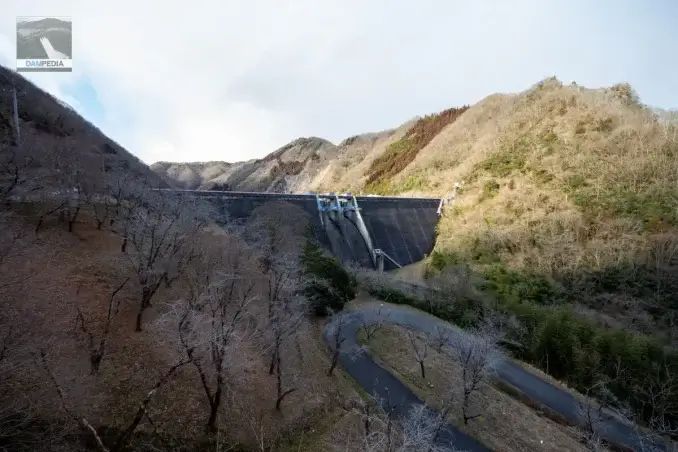 Cherry blossom trees on the right bank and the downstream face of the Kawamoto Dam embankment